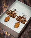 Layered wooden lotus flower earrings with silver bow stud tops displayed in a premium white Slate & Ember jewelry gift box.