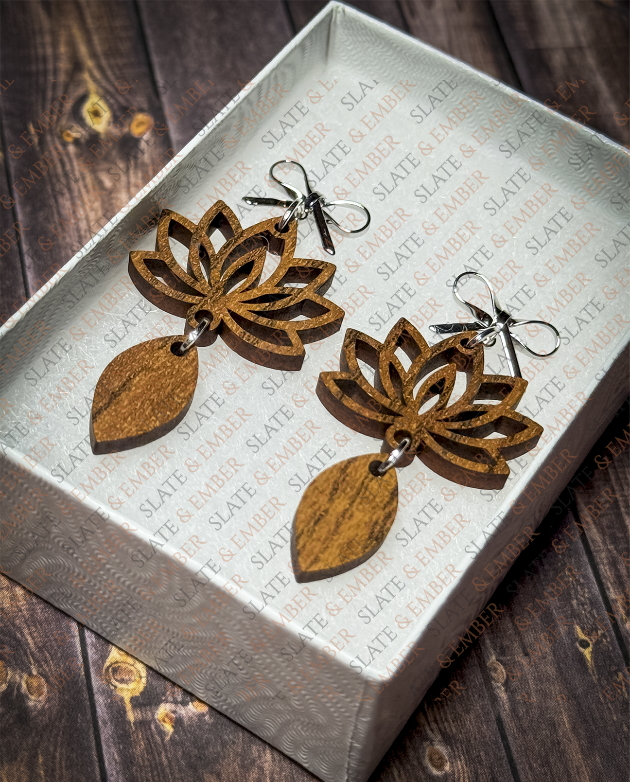Layered wooden lotus flower earrings with silver bow stud tops displayed in a premium white Slate & Ember jewelry gift box.