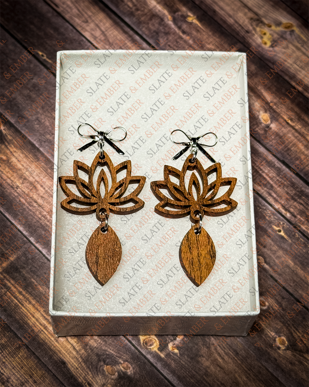 Layered wooden lotus flower earrings with silver bow stud tops displayed in a premium white Slate & Ember jewelry gift box.