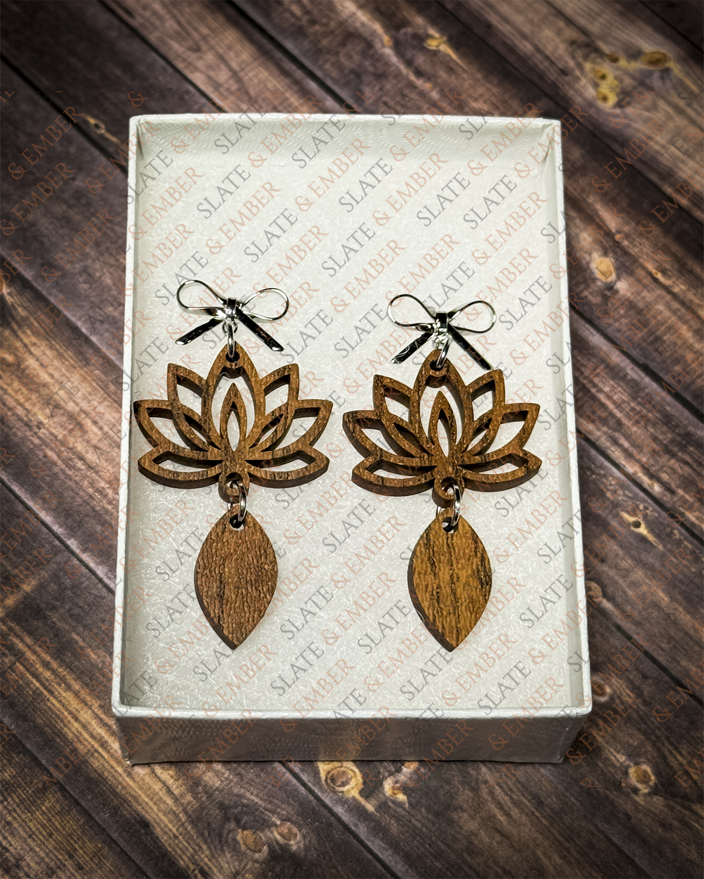 Layered wooden lotus flower earrings with silver bow stud tops displayed in a premium white Slate & Ember jewelry gift box.